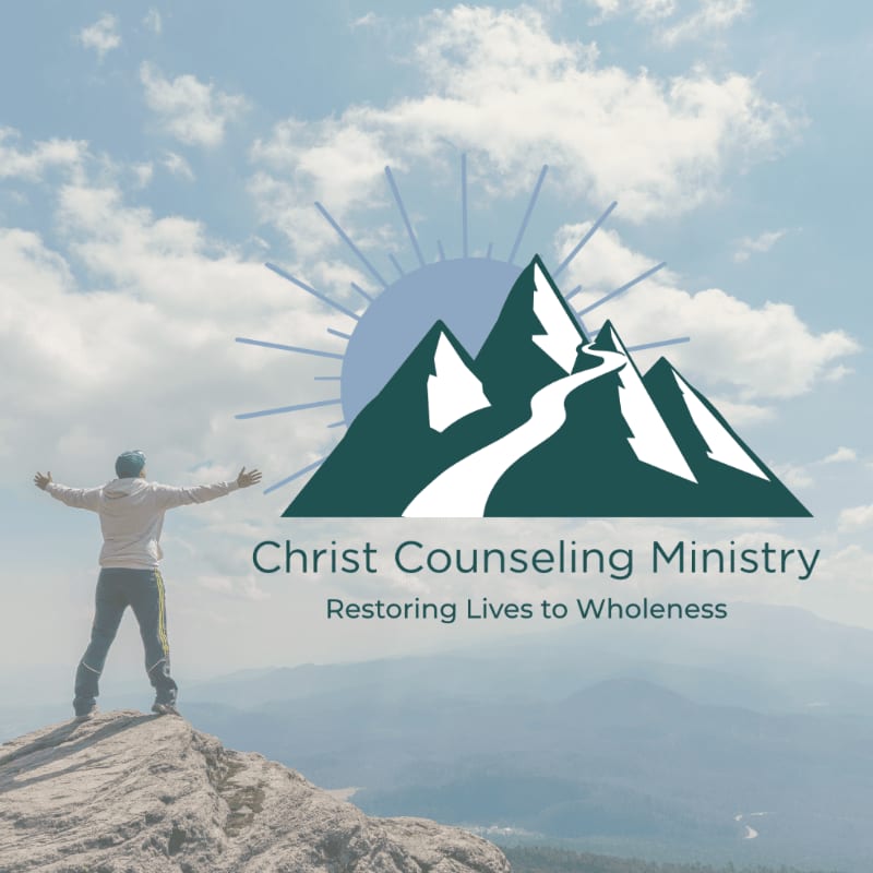 A person stands with arms outstretched on a rocky peak in the foreground, while a stylized mountain logo with the text "Christ Counseling Ministry" is superimposed on a hazy mountain range and sky in the background.