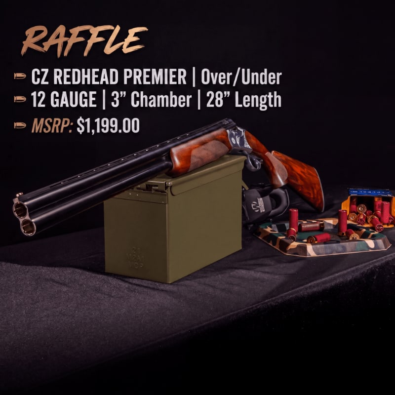 A CZ Redhead Premier shotgun rests on an olive drab ammo can in the foreground, with a display of shotgun shells and a camouflage pattern in front of a dark, textured background.