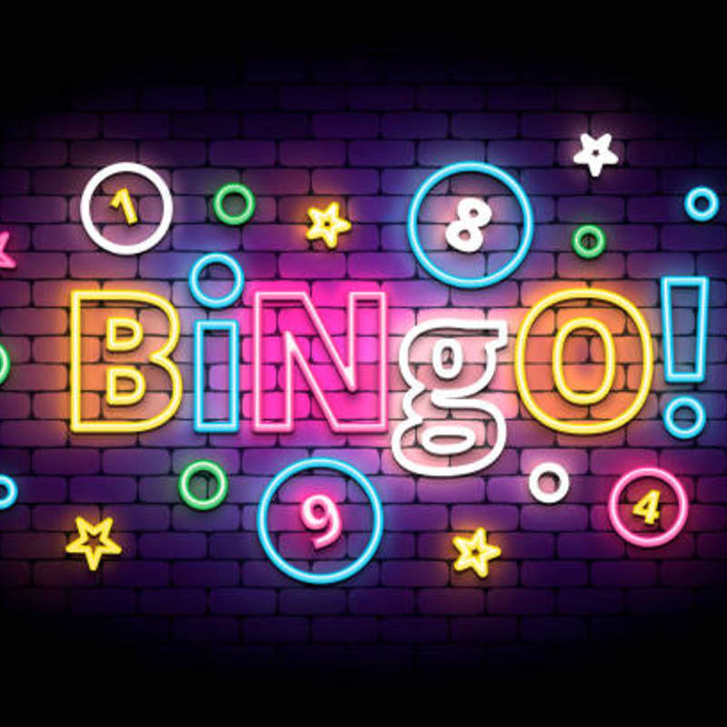 Neon lights spell out "BINGO!" with numbers and stars against a brick wall background.