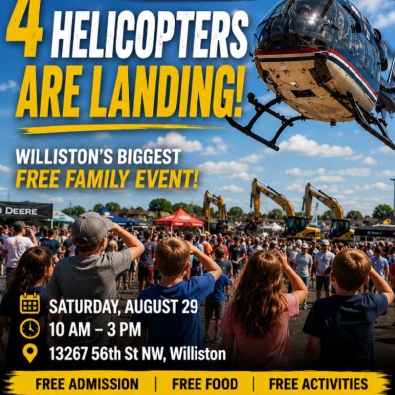 A helicopter hovers over a large crowd gathered for a free family event, with construction equipment visible in the background under a bright sky.