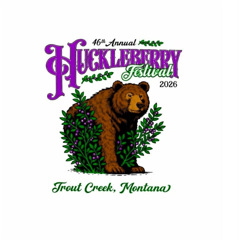 A brown bear peeks out from behind a bush of purple huckleberries, with the text "46th Annual Huckleberry Festival 2026 Trout Creek, Montana" above and below.