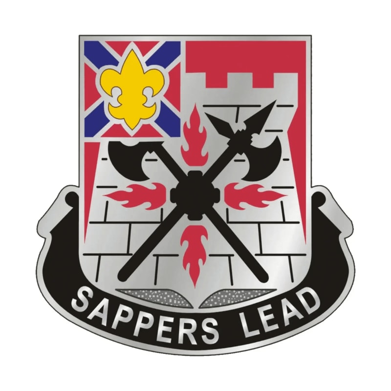 A silver and red crest with a yellow fleur-de-lis and crossed axes over a brick wall is set against a white background, with "SAPPERS LEAD" inscribed on a black banner below.