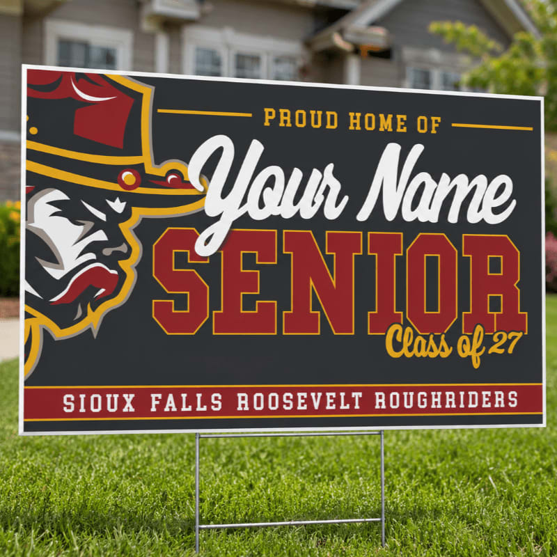 A "Proud Home of Your Name Senior Class of 27 Sioux Falls Roosevelt Roughriders" yard sign stands on green grass in front of a house.