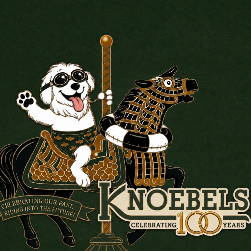 A happy white dog wearing goggles and patterned shorts rides a carousel horse with a life preserver, set against a dark green background with a "Knoebels Celebrating 100 Years" logo.