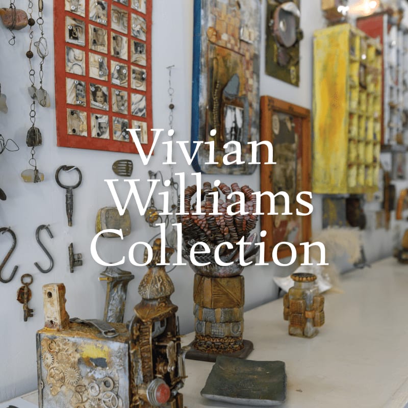 Various eclectic art pieces, including metal sculptures and framed collages, are displayed on a shelf in front of a wall adorned with more artwork.