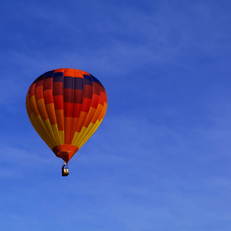 photo of red hot air balloon on sky