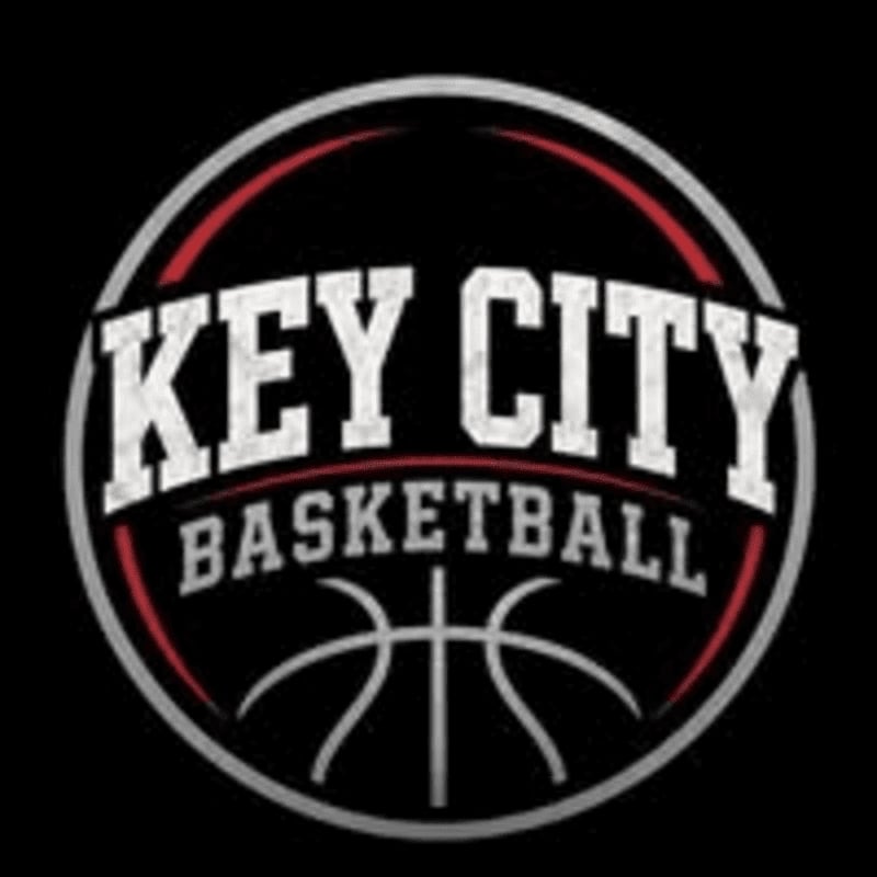 A circular logo with "KEY CITY BASKETBALL" written in white text against a black background, featuring a basketball graphic in the foreground.