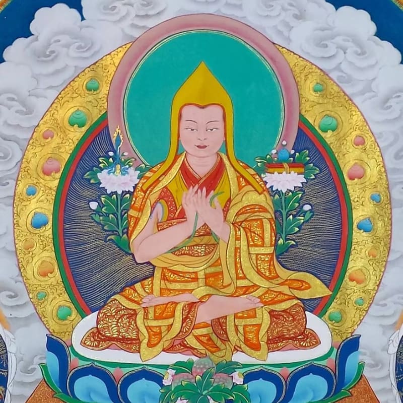 A seated figure in yellow robes with hands clasped in prayer is surrounded by a golden halo and clouds.
