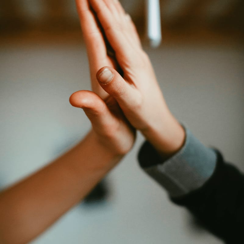 person in black long sleeve shirt holding hand of person in black long sleeve shirt