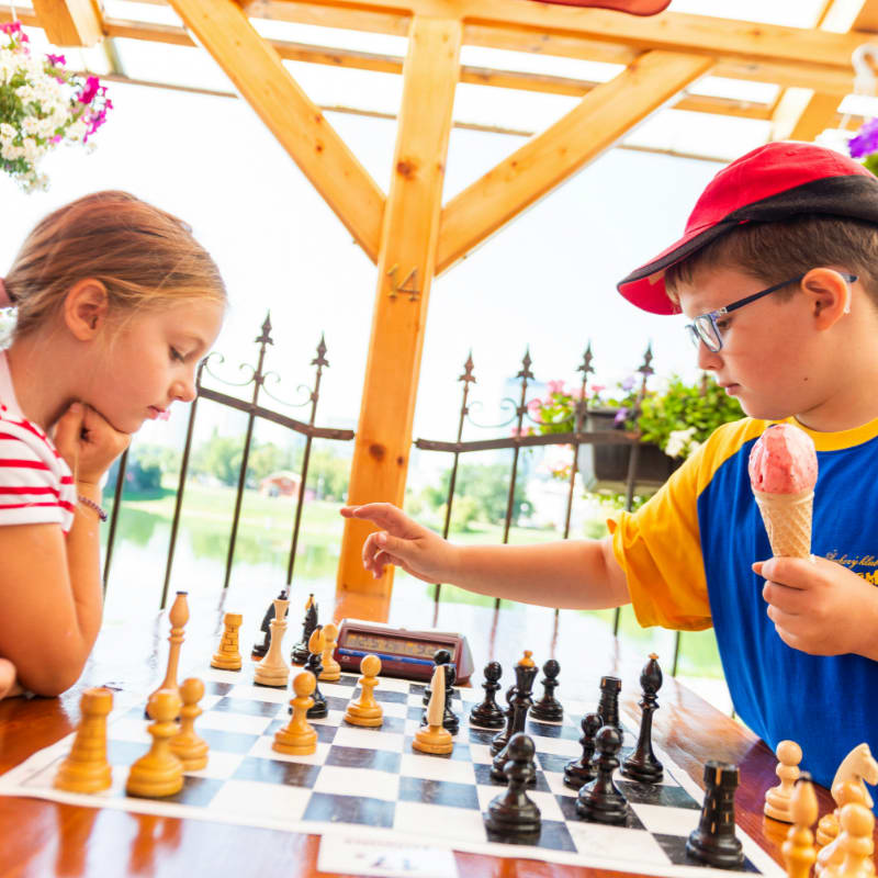 boy in blue t-shirt playing chess