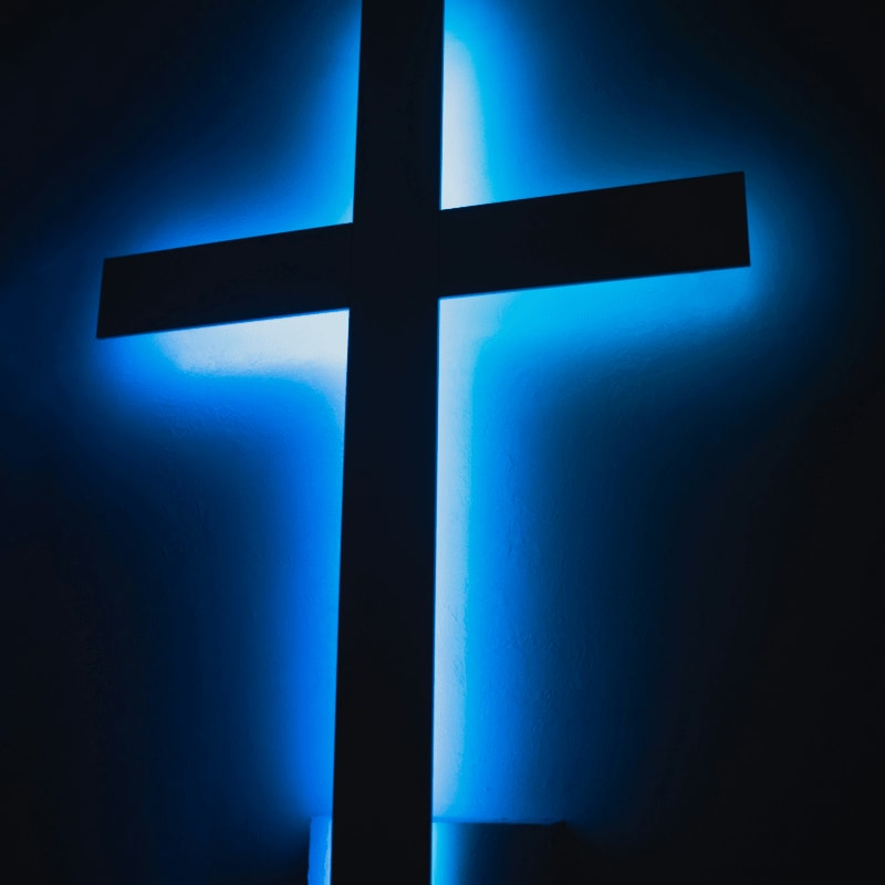 brown wooden cross on orange background