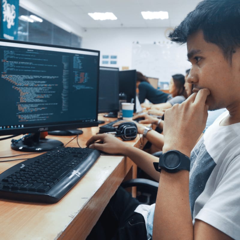 person holding a computer mouse in a room