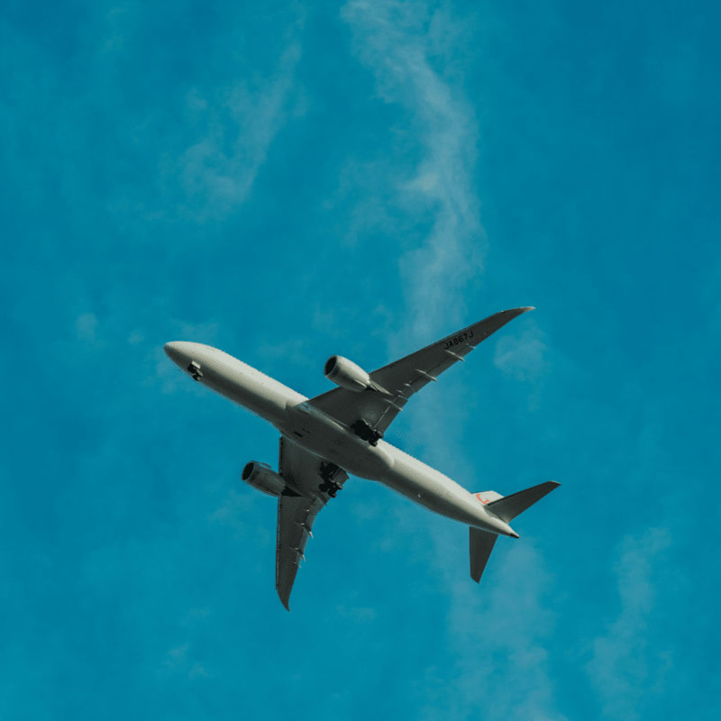 gray airplane flying during daytime