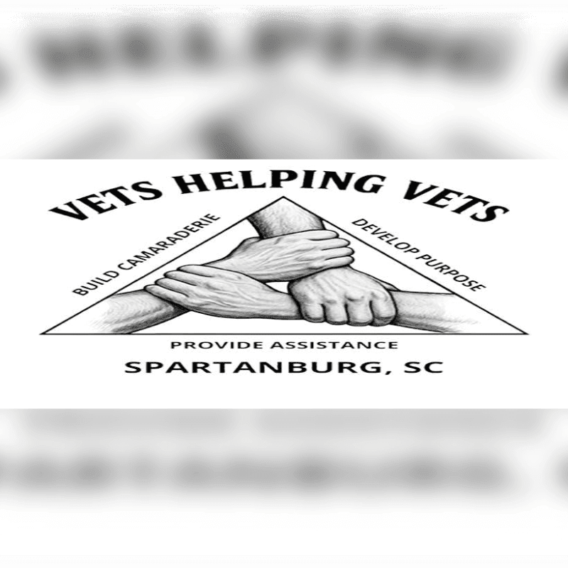 Three clasped hands form the center of a triangle logo with text about "VETS HELPING VETS" and "SPARTANBURG, SC" in the background.