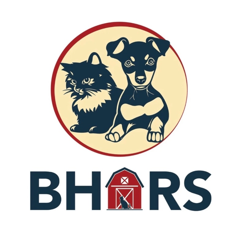 A dark blue cat and a black and tan puppy sit side-by-side within a red-bordered cream circle, with the text "BHARS" and a barn graphic below.