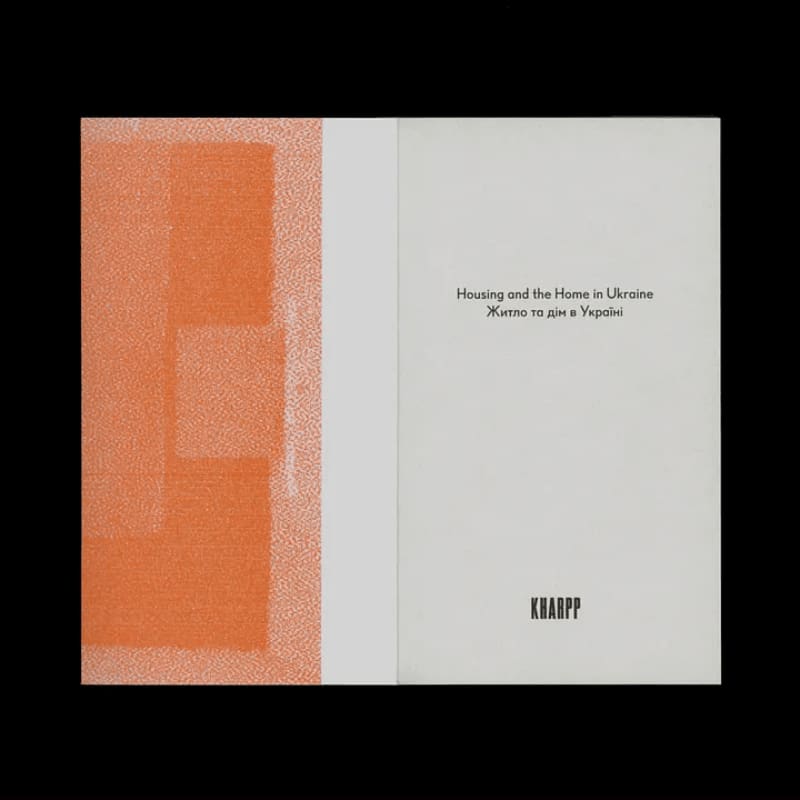 An open book displays an abstract orange design on the left page and text titled "Housing and the Home in Ukraine" with a publisher's logo on the right page.