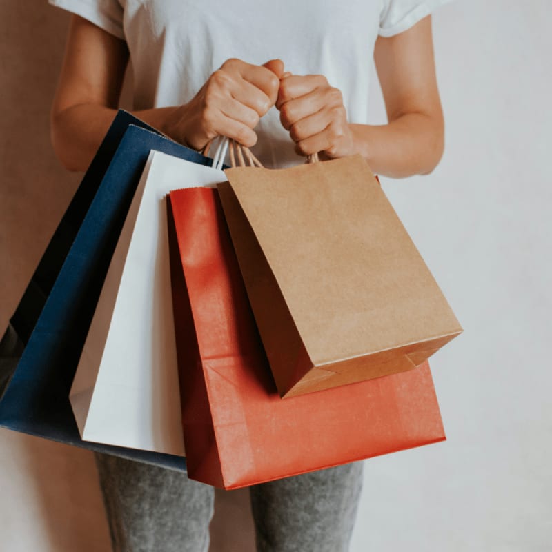 Person holding colorful shopping bags