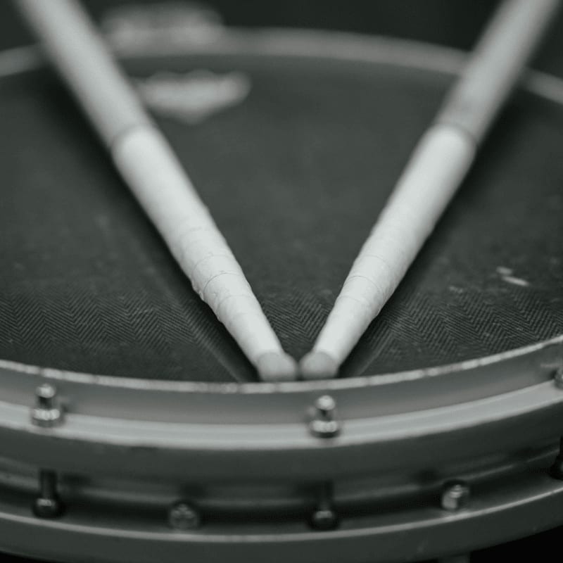 Two drumsticks resting on a drum