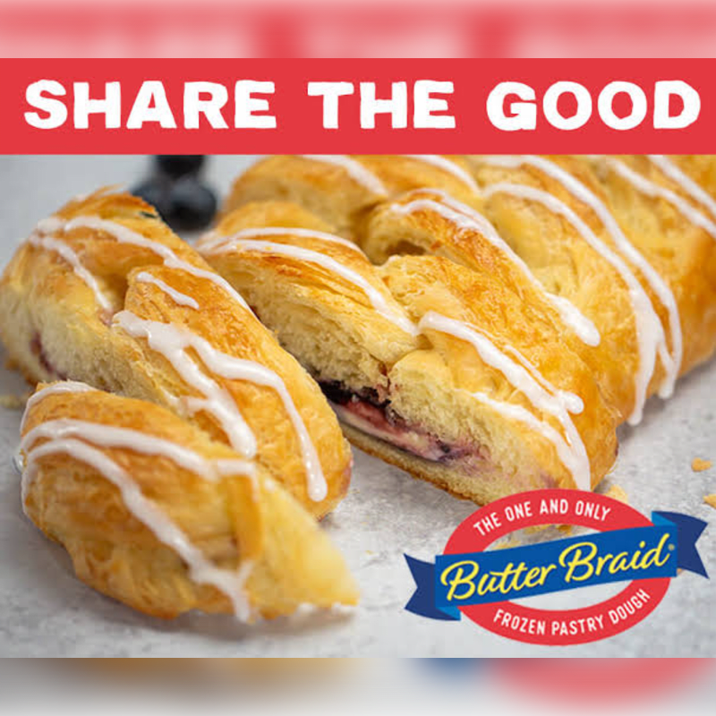 A braided pastry with white icing and blueberries in the foreground is set against a red banner with the words "SHARE THE GOOD" and a Butter Braid logo in the background.
