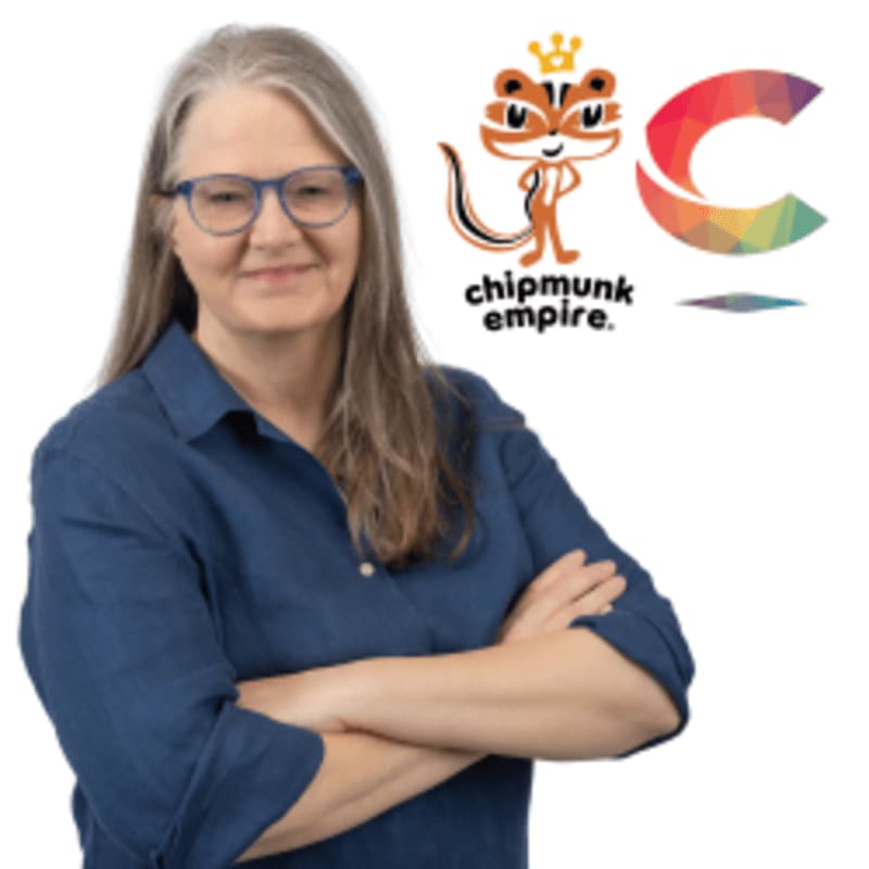 A woman with glasses and graying hair stands with her arms crossed in front of a white background featuring a cartoon chipmunk logo and a colorful "C".