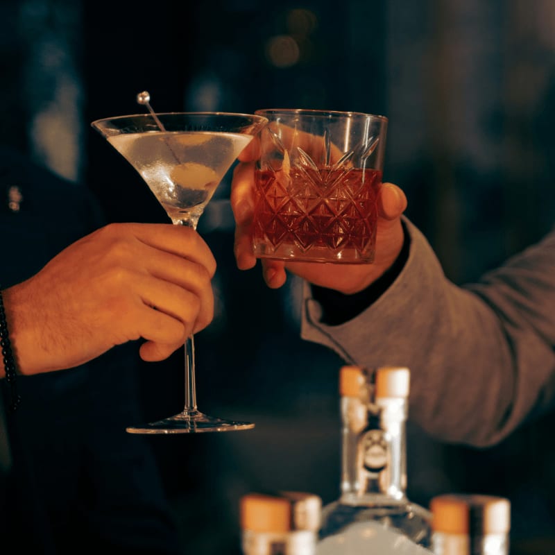 a couple of people that are holding some drinks