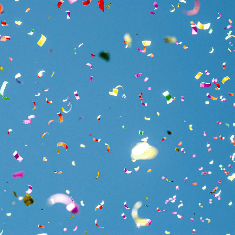 colorful confetti against blue sky