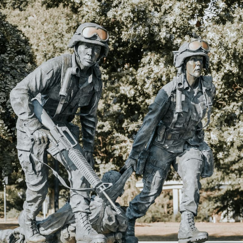 a statue of two soldiers holding a rifle