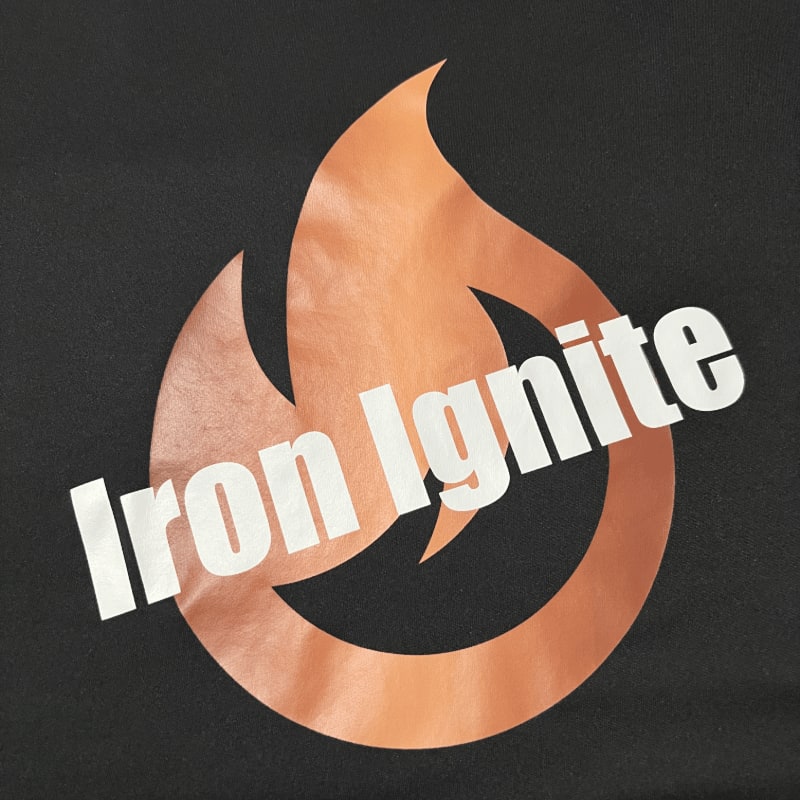 A copper-colored flame logo with the words "Iron Ignite" in white is centered on a black background.