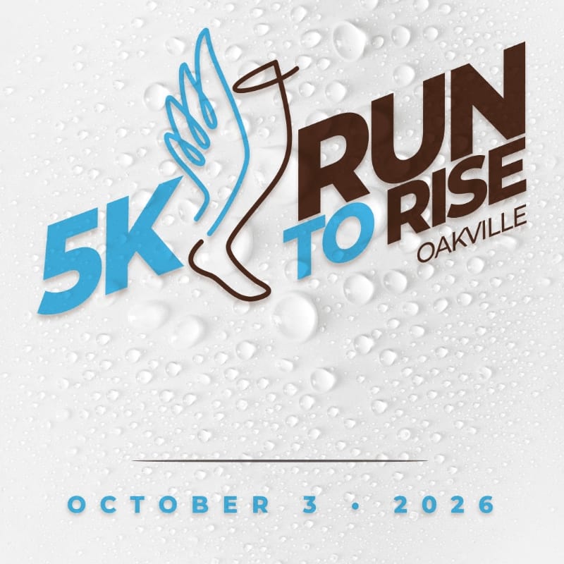 Water droplets cover the textured background, while the foreground features bold blue and brown text for "5K RUN TO RISE OAKVILLE" with a stylized wing and leg graphic, and the date "OCTOBER 3, 2026" at the bottom.