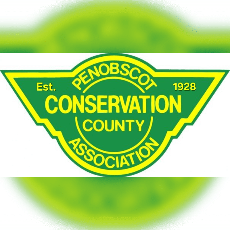 A green and yellow triangular logo for the Penobscot County Conservation Association, established in 1928, is centered against a blurred green background.