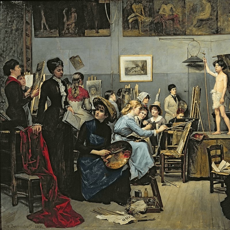 In the foreground, women artists gather around a palette and easel, while in the background, a young male model poses in an art studio filled with sculptures and paintings.