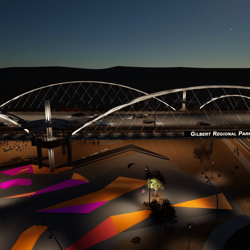 A brightly lit skate park with colorful geometric patterns in the foreground is set against a backdrop of a modern bridge and distant hills under a starry night sky.