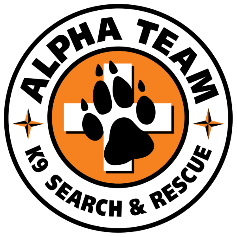 A black paw print is centered on a white cross within an orange circle, surrounded by the words "ALPHA TEAM K9 SEARCH & RESCUE" in a black ring with four-pointed stars on either side.