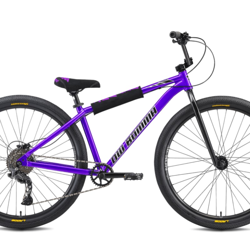 A vibrant purple BMX bike with black tires and handlebars stands against a plain white background.