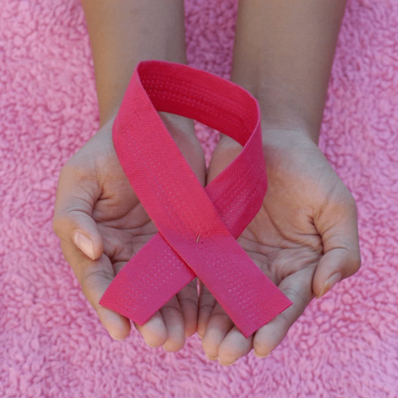 person with pink band on her left hand