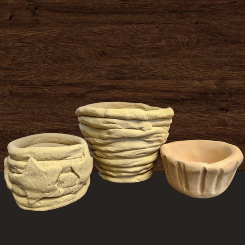 Three textured, light-colored ceramic pots, one with a star design, sit on a dark surface against a dark wood-grain background.