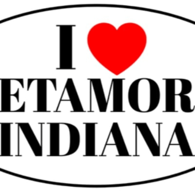 A red heart replaces the "o" in "I" above the words "ETAMORE" and "INDIANA" within an oval border.