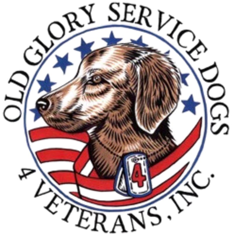 A dog's head is in the foreground, with a red, white, and blue ribbon and dog tags, set against a circular background of stars and stripes.