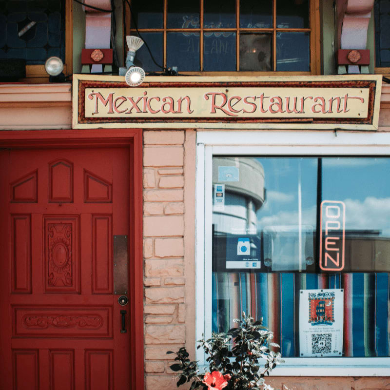 red wooden door beside black motorcycle