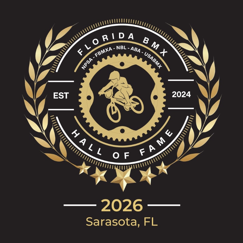 A circular emblem with a BMX rider in the center, surrounded by laurel leaves and stars, is set against a black background with the text "2026 Sarasota, FL" below.
