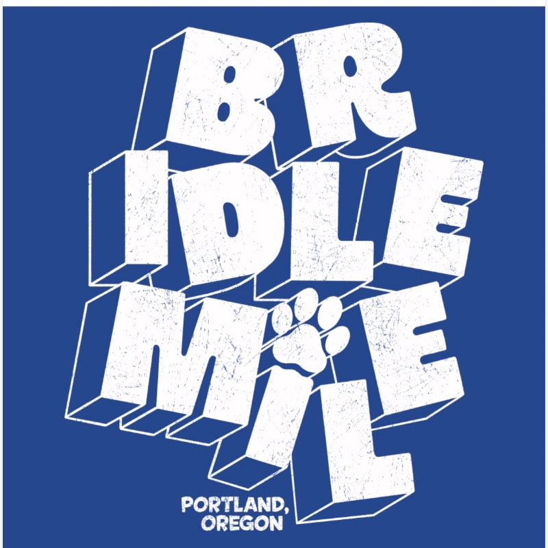 White 3D text spelling "BRIDLE MILE" with a paw print in the center, set against a solid blue background with "PORTLAND, OREGON" in smaller text at the bottom.
