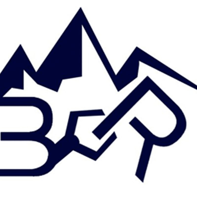 A dark blue mountain range forms the background for the letters "BER" in the foreground.
