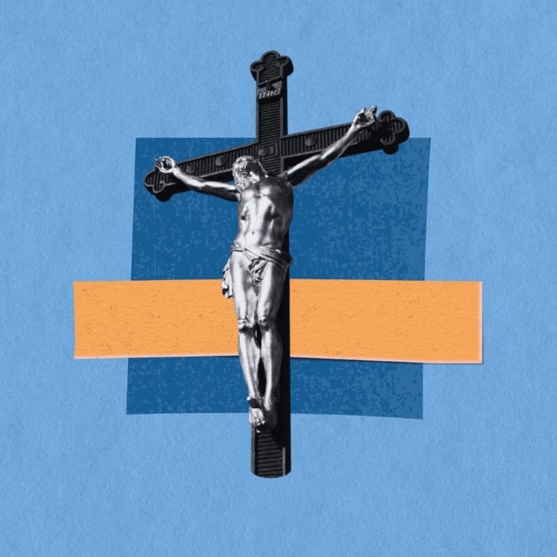 A silver crucifix of Jesus is centered against a blue background with an orange rectangle and a blue square behind it.