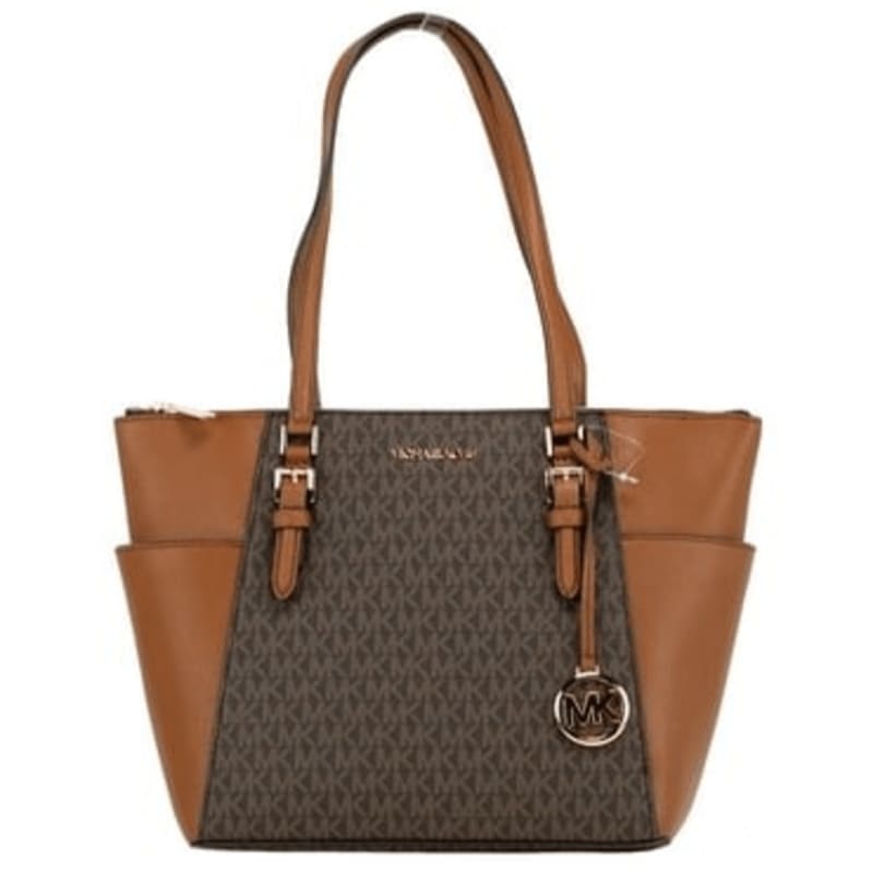 A brown Michael Kors tote bag with a monogram pattern and side pockets stands against a plain white background.