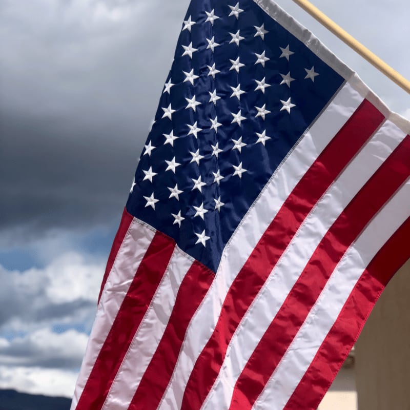 us a flag under cloudy sky during daytime