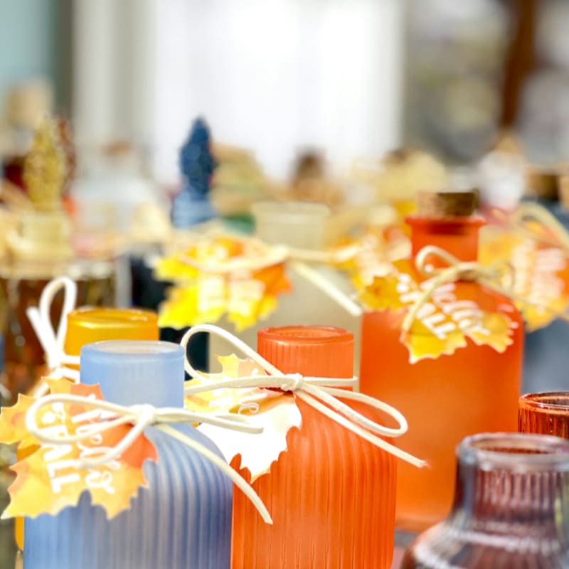 Small decorative bottles with fall leaf tags