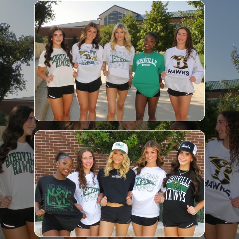 Five young women in athletic wear stand in front of a brick building with trees in the background.