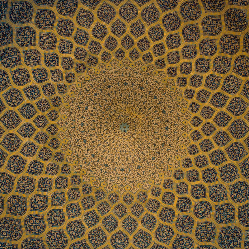 Intricate blue and gold geometric tile patterns radiating across a domed ceiling