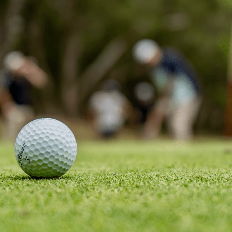 white golf ball on green grass field during daytime