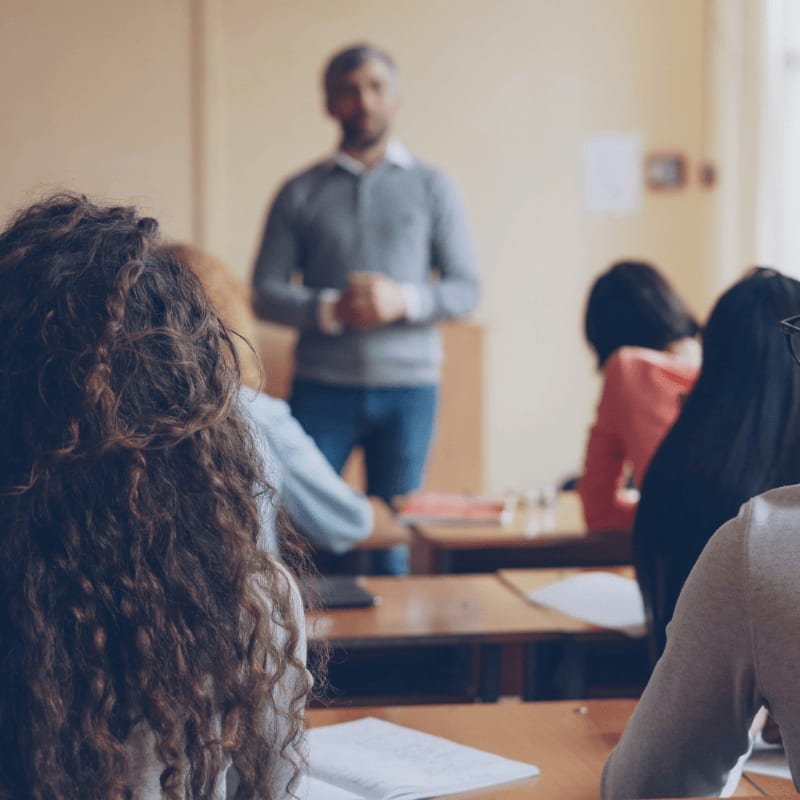 Teacher instructing students in a classroom setting